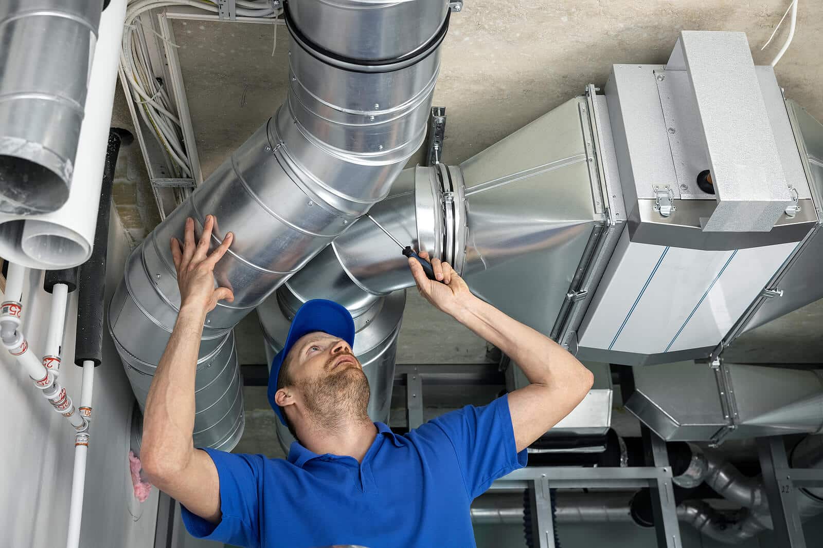 HVAC technician inspecting and repairing air ducts in Menlo Park