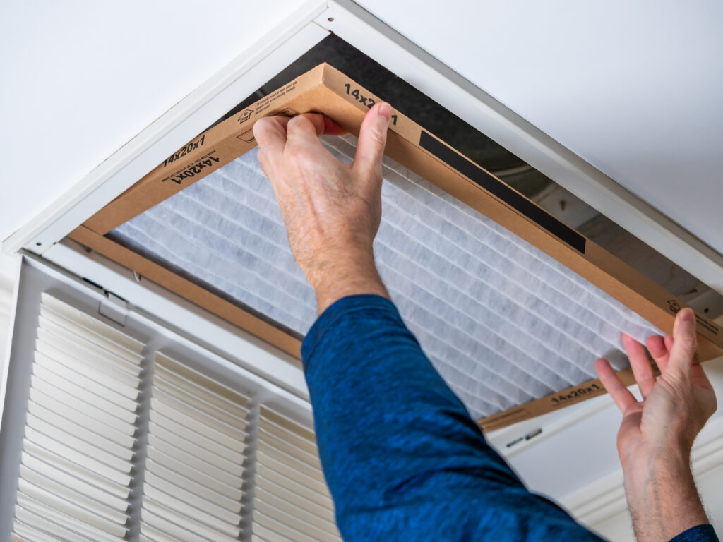 HVAC technician replacing a home air filter in Menlo Park