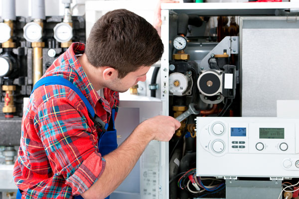 Heating technician repairing boiler controls in Menlo Park