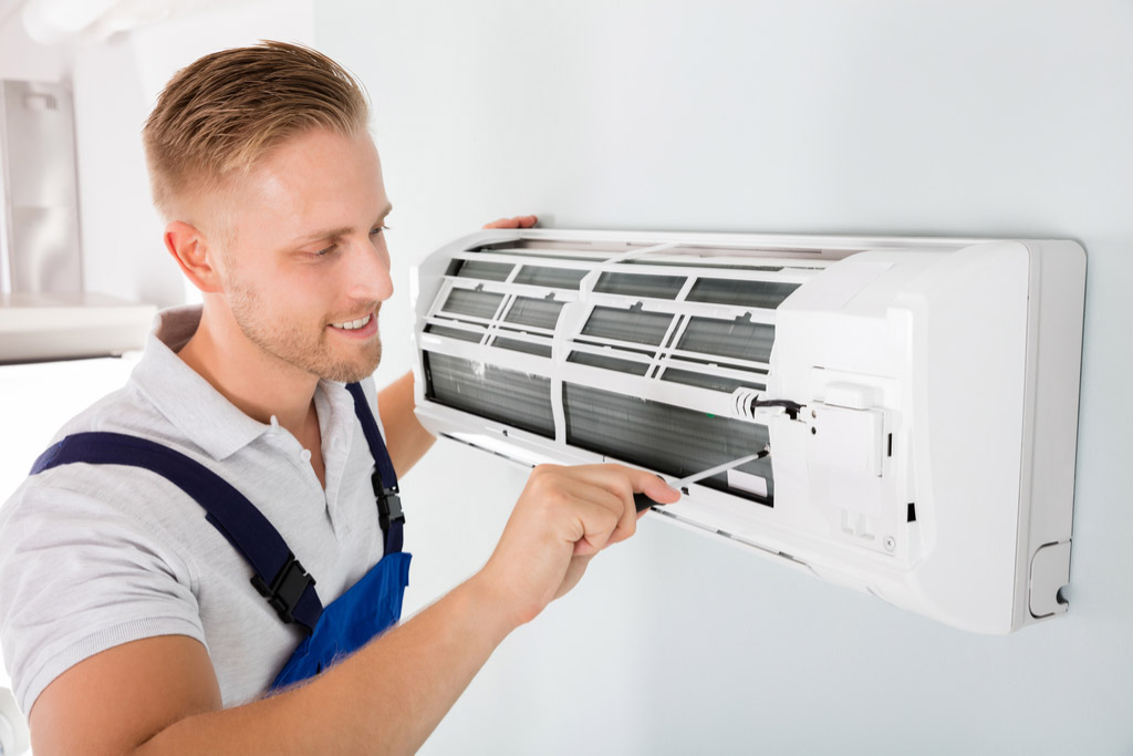 HVAC technician maintaining a ductless air conditioner in Menlo Park