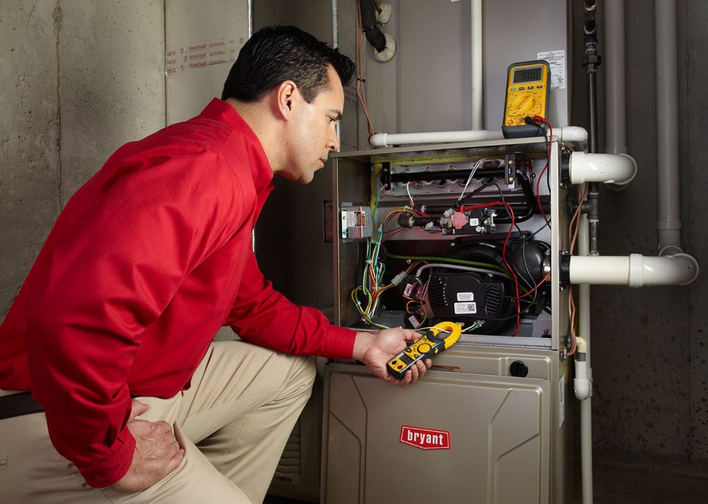 Heating technician diagnosing a furnace repair in Menlo Park