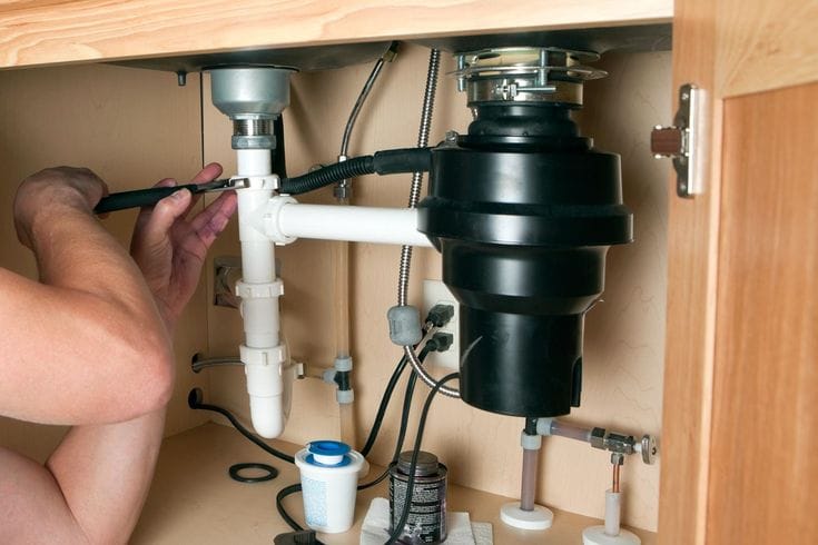 Plumber repairing a garbage disposal in Menlo Park