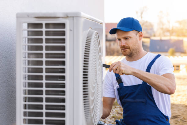 HVAC technician servicing an outdoor air conditioner in Menlo Park