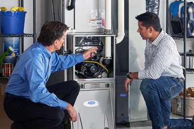 Technician evaluating a furnace for repair or replacement in Menlo Park