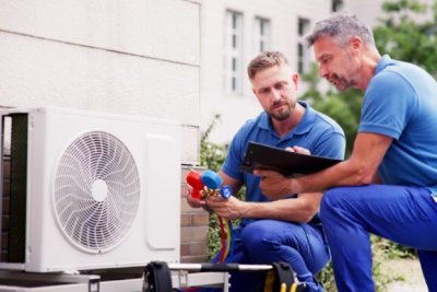 HVAC technicians installing an outdoor air conditioning unit in Menlo Park